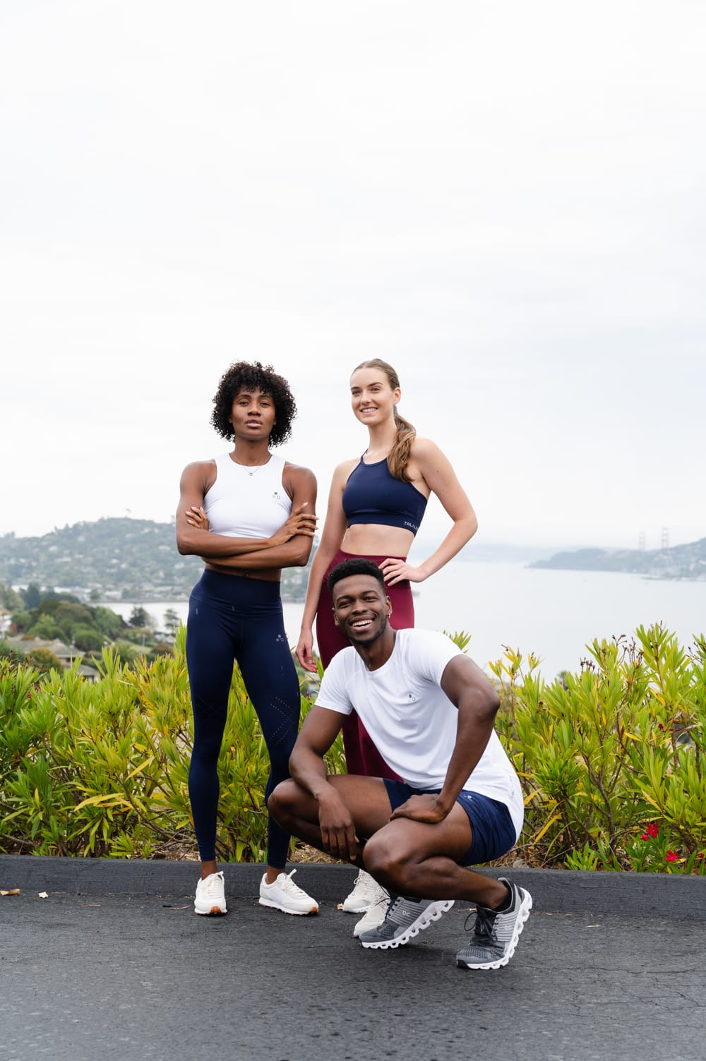 three people wearing athletic clothing