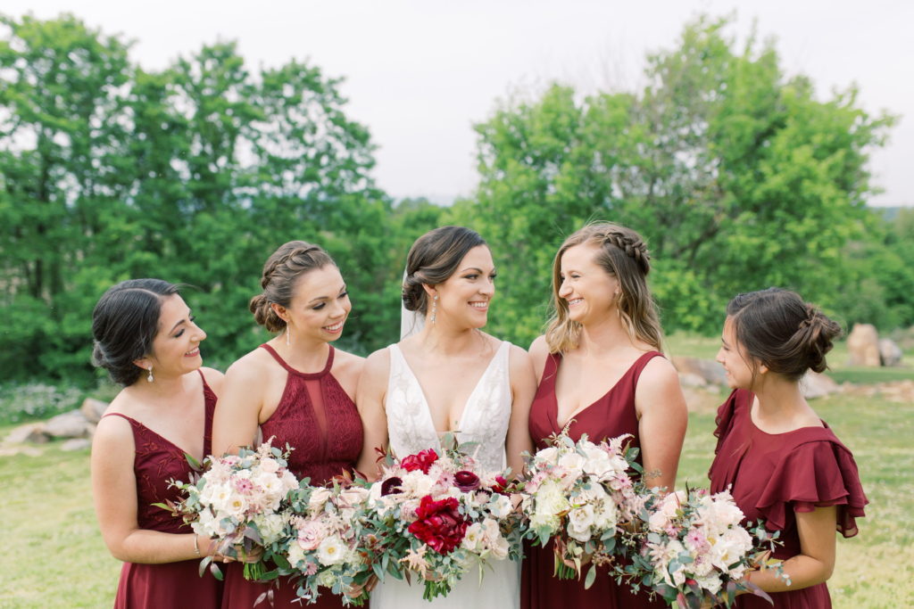 bride and bridesmaids in maroon dresses holding bouquets for Timeless Wedding AYS blog